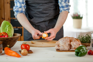male preparing chicken for cooking