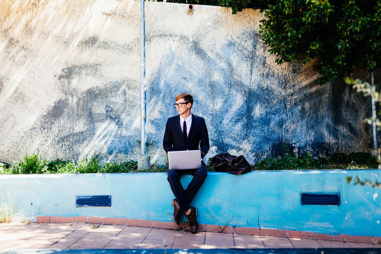Elegant Businessman Working With Laptop Outdoor 