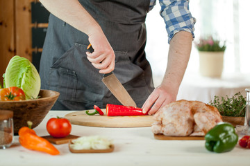 male preparing chicken for cooking
