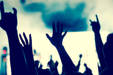 crowd with raised hands at concert - summer music festival