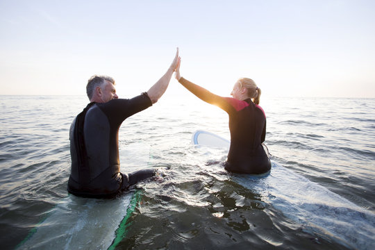 Surf couple at beach.