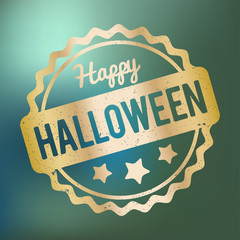 Happy Halloween rubber stamp gold on a blue bokeh background.