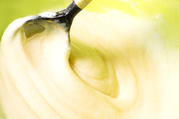 Mixing cream with a wooden spoon