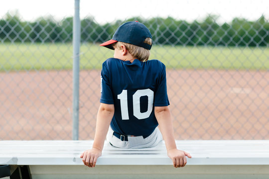 Young baseball player sitting on the bench