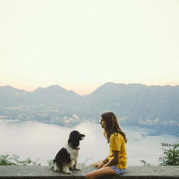 Girl and dog looking each other