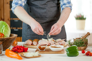 male preparing chicken for cooking