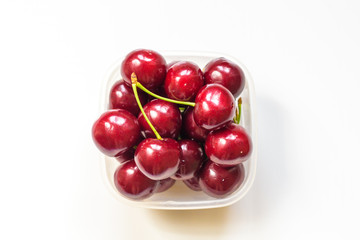Red Cherries in a glass bowl isolated on white