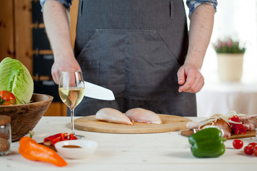male preparing chicken for cooking