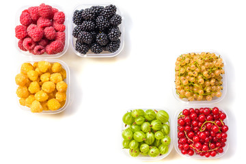 Collage of different fruits and berries isolated on white. Blueberries, cherries, blackberries, grapes, strawberries, currants. Collection of fruits and berries in a bowl. Top view