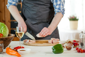 male preparing chicken for cooking