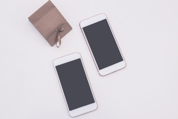 Two empty mobile phones together on couple hands. Love or wedding or valentine concept. Vintage filtered.