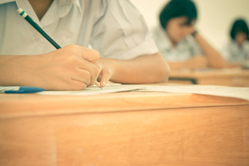 Blurred of Asian girls students writing test exams on paper for Admissions