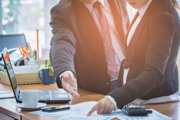 Business team discussing the charts and graphs at meeting present on office desk.