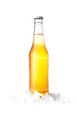 Front view of a closed bottle of blonde beer with lemon inside and white background