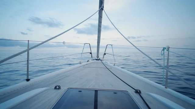 Clean and scenic front view on swaying sailing boat parked at twilight in wavy sea or ocean, before long adventure trip