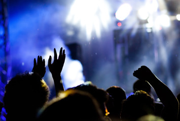 crowd with raised hands at concert - summer music festival