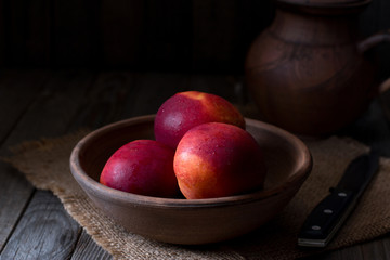 Peaches in a ceramic bowl