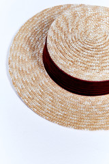 Fototapeta na wymiar Straw hat of light straw with velvet ribbon beautiful stylish fashion accessory for summer resort on white background in studio.