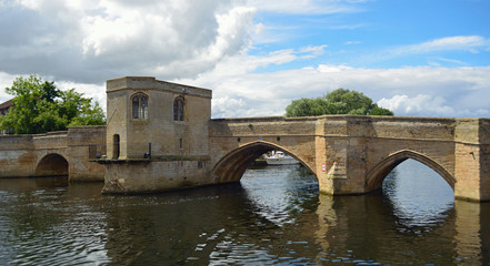 Obraz premium The Historic Parkhorse Bridge at St Ives Cambridgeshire with Chapel