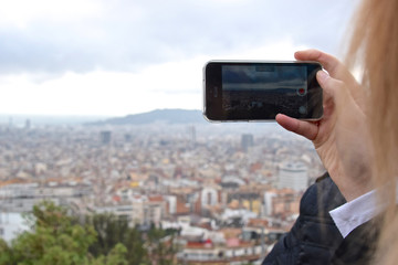 Woman records a video overlooking a large city