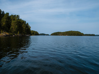 Scenery of the finnish lakes in summer surrounded by deep green forests