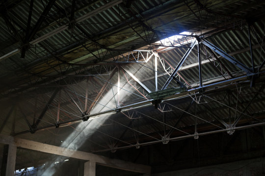light beams protruding from old factory ceiling 