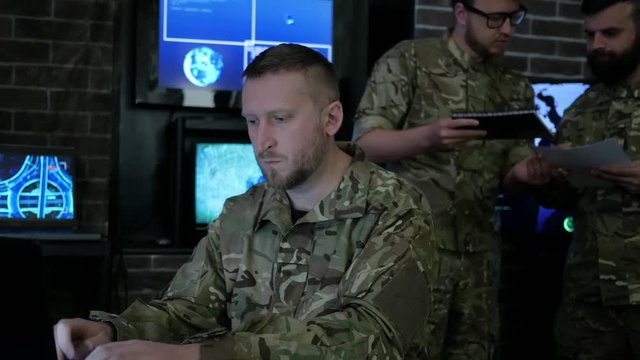 soldier male portrait, technical control, tracking system, IT war, strategy warfare, field headquarters, military staff, attack and security, cyber safety, on soldiery headquarter or war base, control