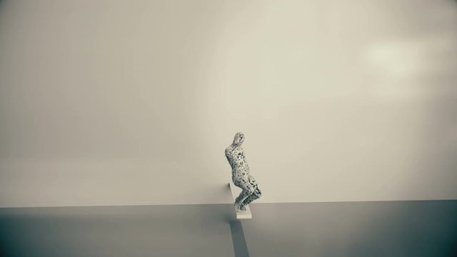 Abstract android falls to the floor and breaks into cubes.