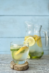 Refreshing lime lemonade on a rustic wooden background