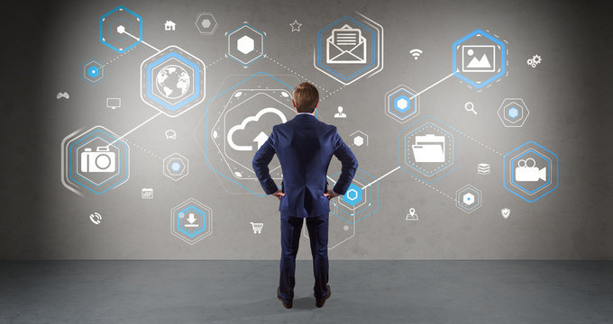 Businessman using cloud interface on a wall 3D rendering