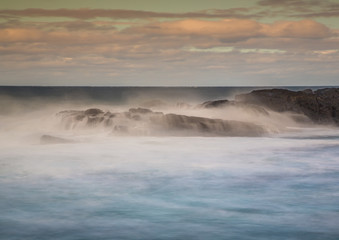 Long time exposure of waves around rocks at the Wild Coast at the Indian Ocean in South Africa