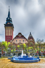 Fototapeta na wymiar Subotica, Serbia - April 23, 2017: Retro building of city hall in Subotica city and blue fountain, Serbia
