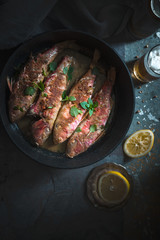 Mullet on a cast-iron frying pan, lemon and beer