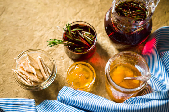 Tea with rosemary, pineapple jam and blue striped napkin