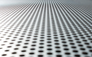 Gray metal background, round perforated metal texture. Reflections and blur.