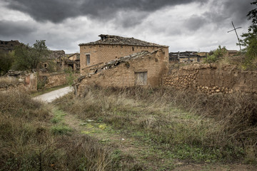 ruins of abandoned rustic houses made of wood and clay in Navapalos, Soria, Spain