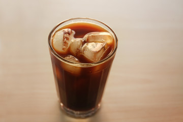 Glass of cold brew coffee on wooden surface