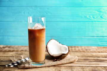 Glass of cold tasty coconut coffee on table