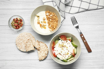 Tasty breakfast with yogurt on table