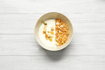 Fototapeta na wymiar Tasty oatmeal with yogurt on table