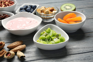 Tasty breakfast with yogurt on table