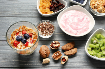Tasty breakfast with yogurt on table