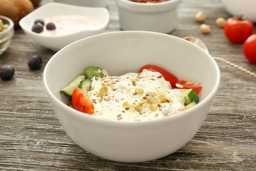 Tasty salad with yogurt on table