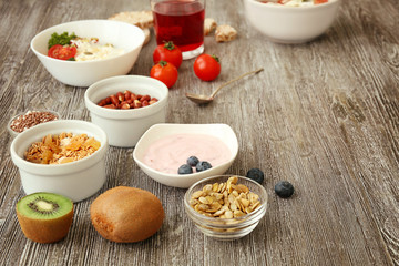 Tasty breakfast with yogurt on table