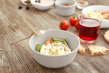 Tasty salad with yogurt on table