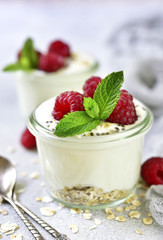 Two portions of homemade natural yogurt with oats,chia seed and fresh berries.Concept of healthy breakfast