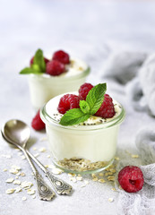 Two portions of homemade natural yogurt with oats,chia seed and fresh berries.Concept of healthy breakfast