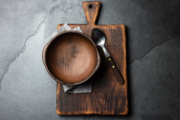 Cooking background. Vintage empty clay bowl on cutting boards, copy space