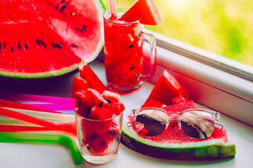 On a piece of watermelon are sunglasses. Watermelon delight