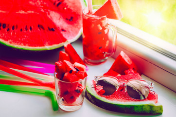 Sunglasses lie on a watermelon.